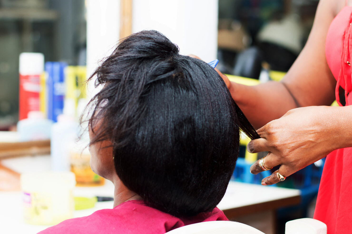 The hairdresser creates a model of hair on the head of her clent.