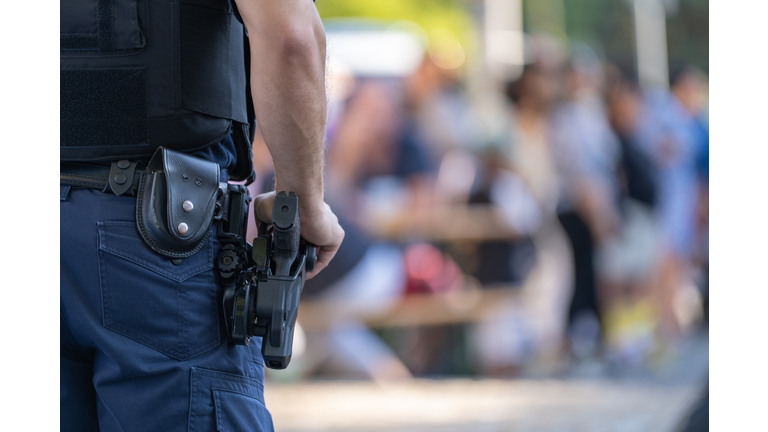 police officer with weapon at public events Close-up police equipment, weapon