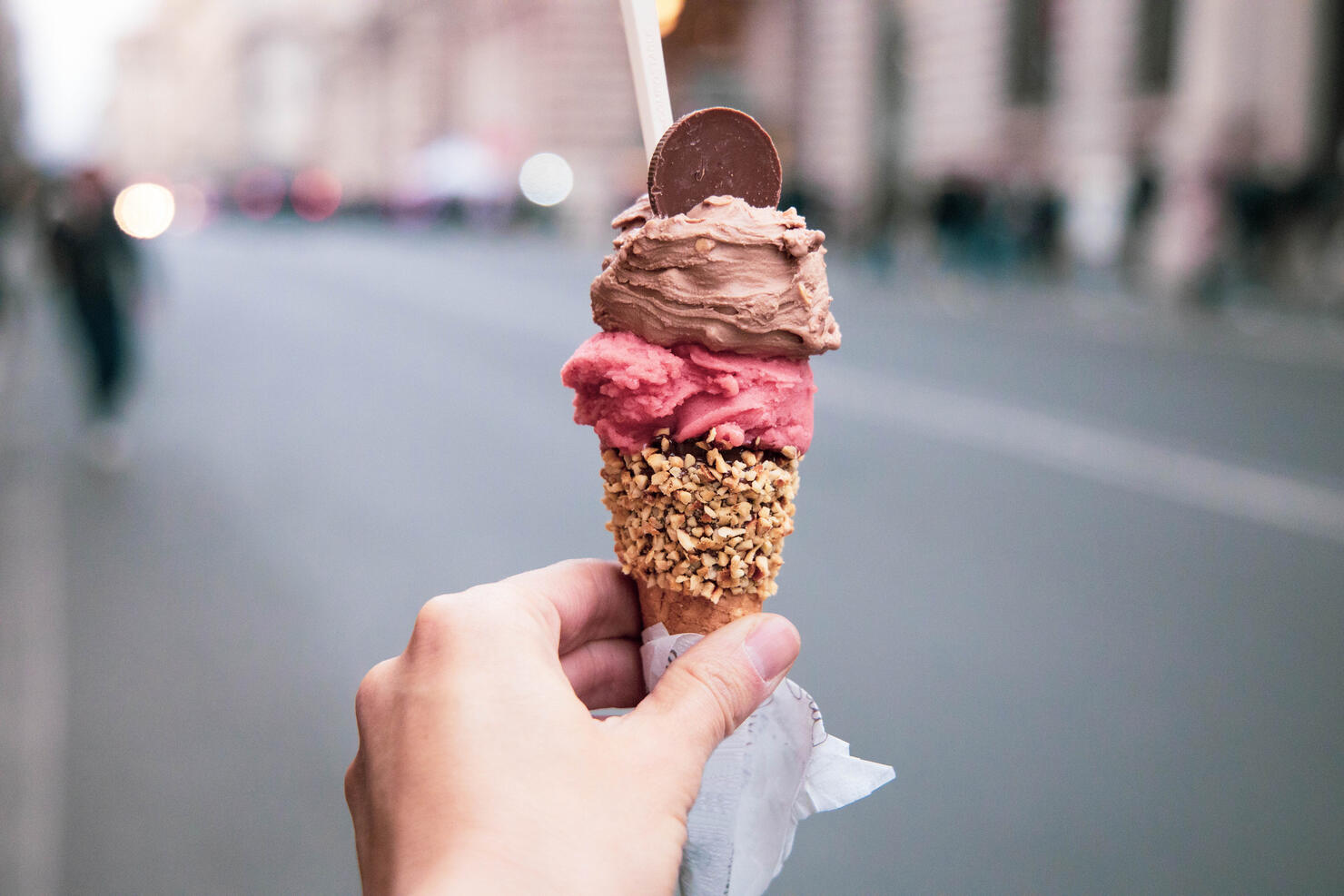 Trying tasty ice cream with levels in Rome during travel vacations.