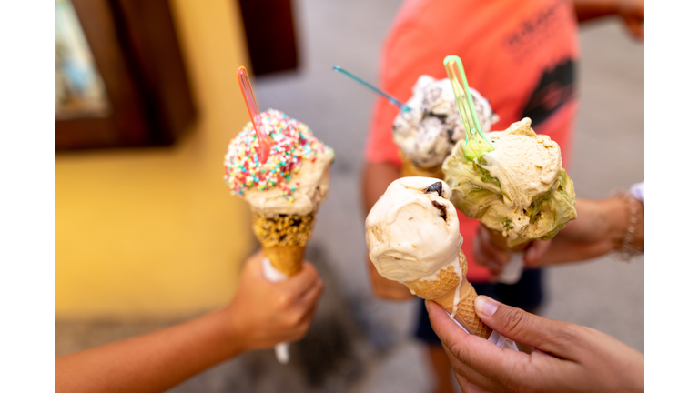 Very appetizing ice cream in the hands of people.