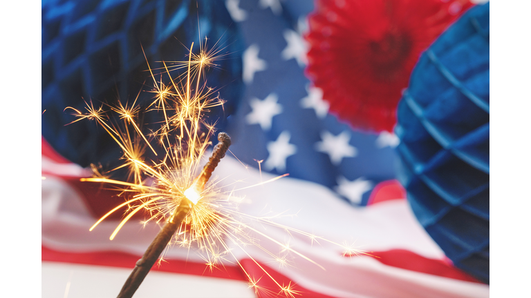US flag with 4th of July paper fan and fireworks