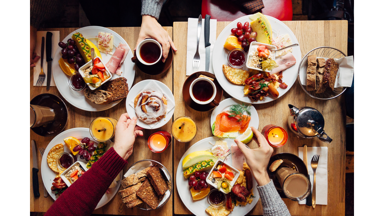 Group of friends having celebration dinner together, directly above view