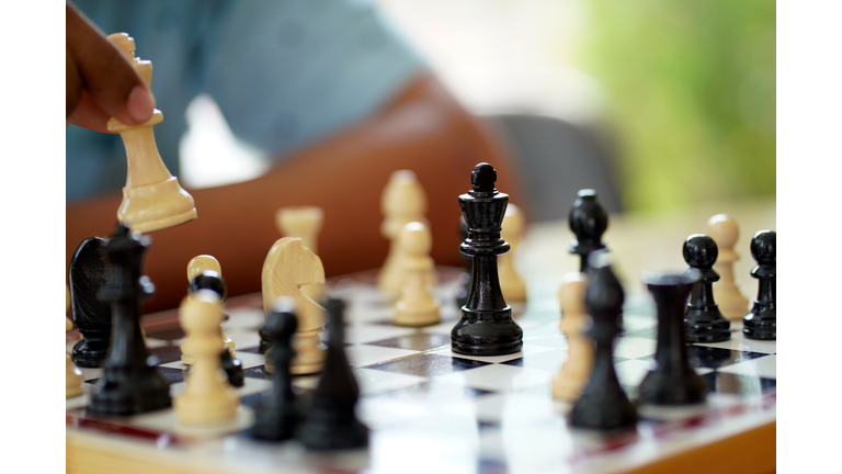 Close-up Businessman playing chess .