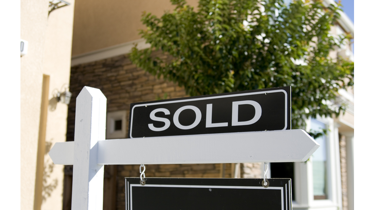 A real estate sign saying sold