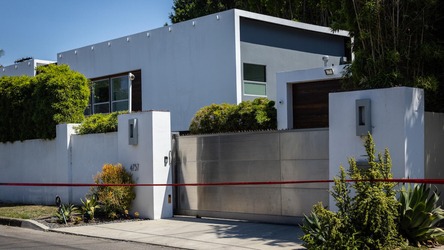 Los Angeles Police Department officials secure the home where Robin Kaye an "American Idol" music supervisor and her husband Thomas Deluca were found killed with gunshot wounds to the head