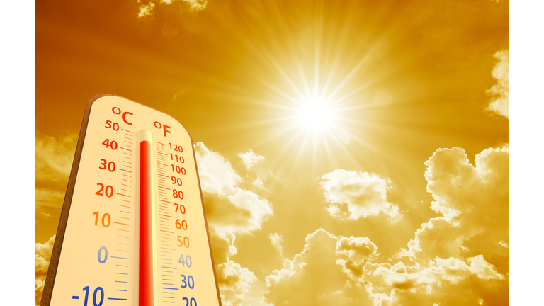 hot temperature,Thermometer on yellow sky with sun shining