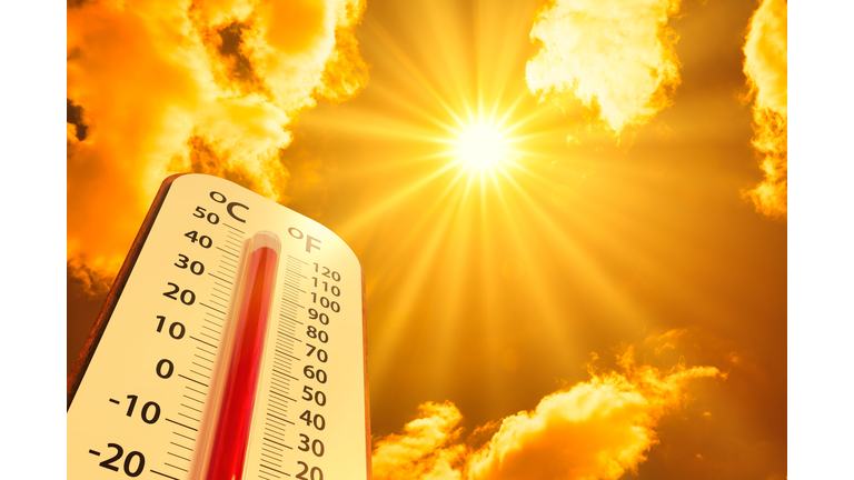 hot temperature,Thermometer on yellow sky with sun shining