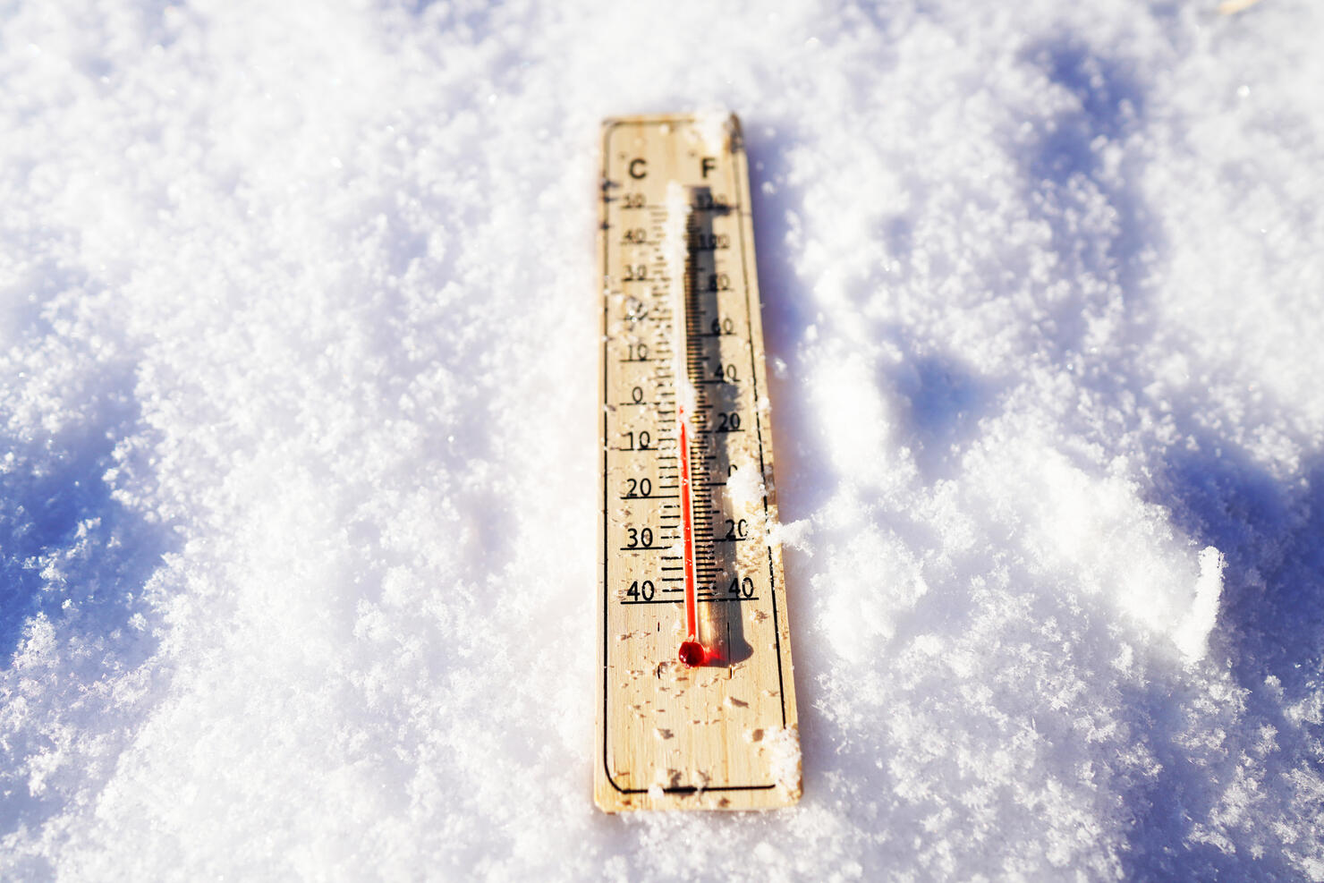 Thermometer on winter snow background. Thermometer for measuring outdoor air temperature.