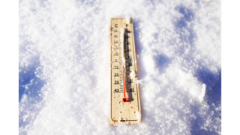 Thermometer on winter snow background. Thermometer for measuring outdoor air temperature.