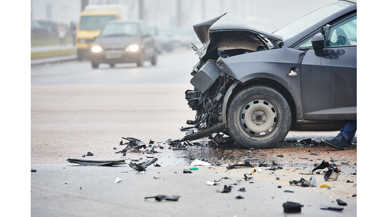 Car crash in urban street with black car
