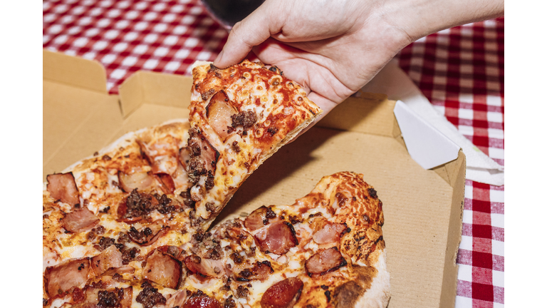 Man holding pizza slice