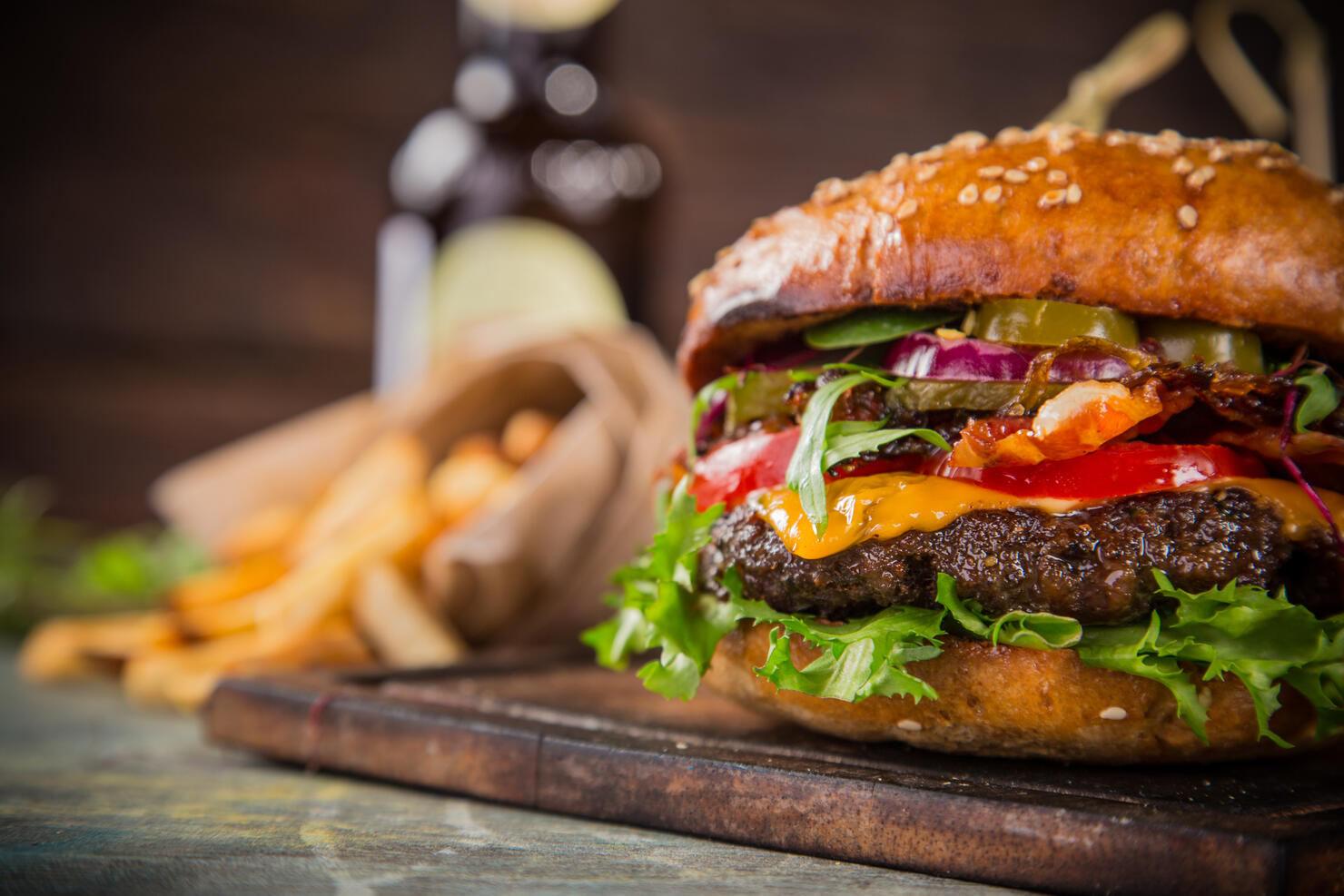 Tasty burgers on wooden table