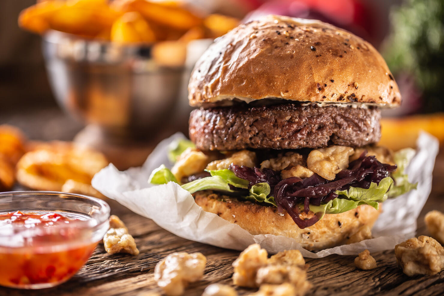 Juicy beef burger in crusty bun served with mayo, chicken pieces, lettuce, mustard, potato fries and chilli dip.