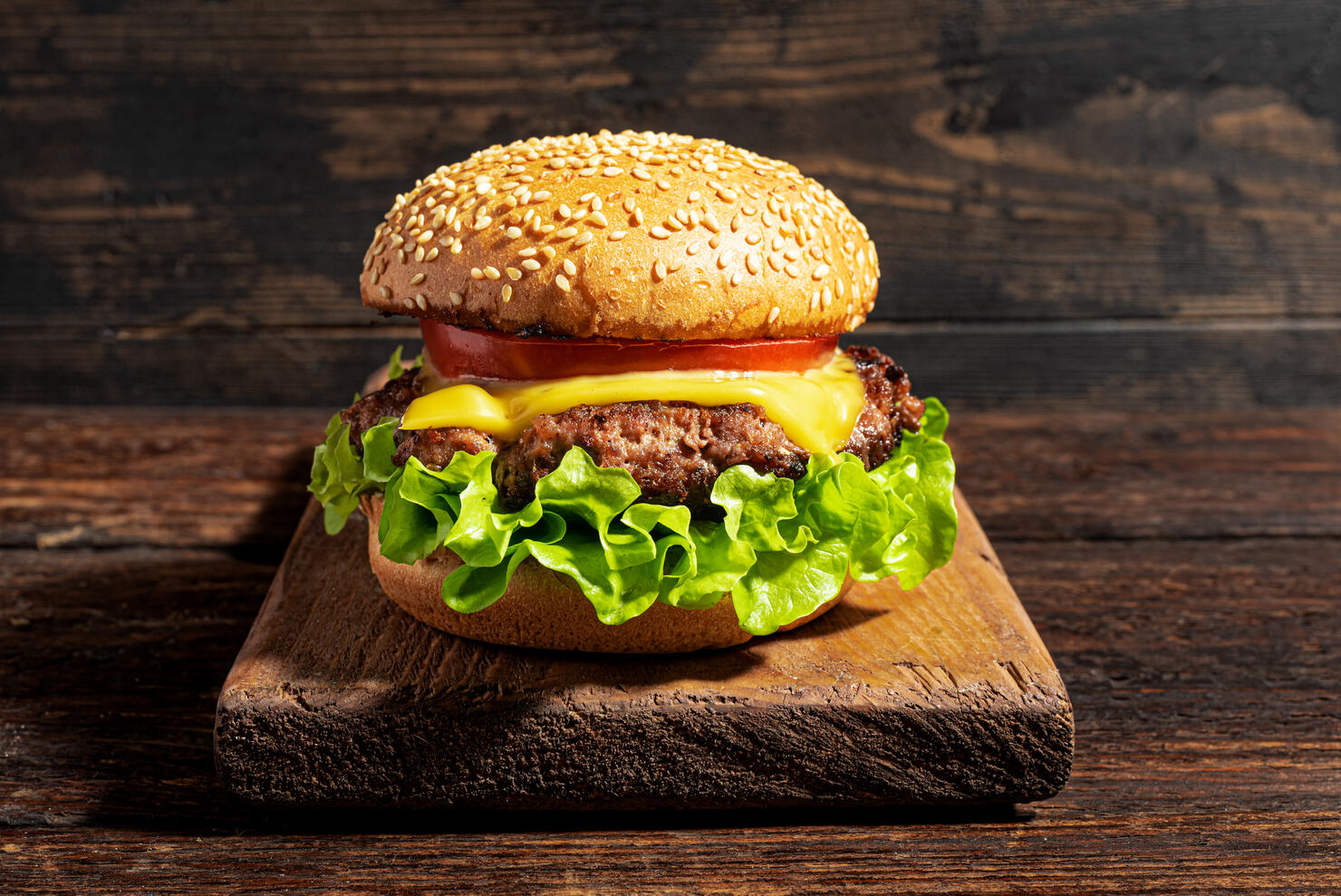 Homemade burger, cheeseburger on dark wooden background
