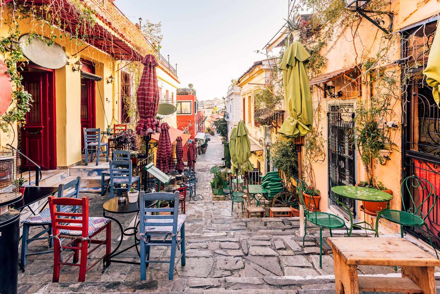 Charming street with cafes and restaurants in Anafiotika neighbourhood, Athens, Greece