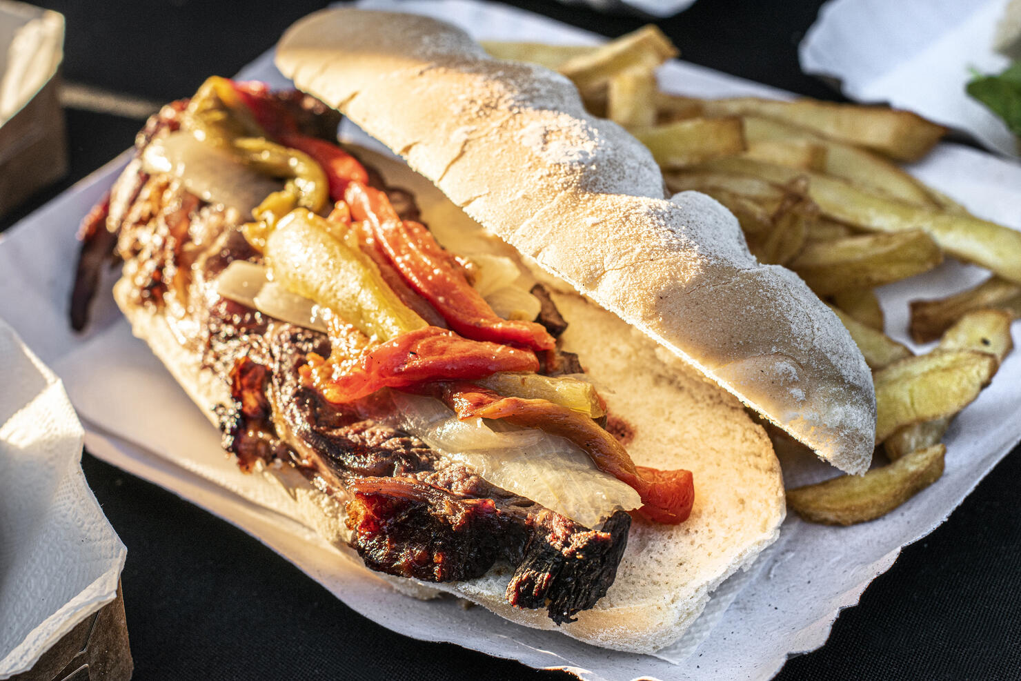 Meat sandwich with sauce, vegetables and French fries. Barbecue. Asado. Traditional Argentine food.