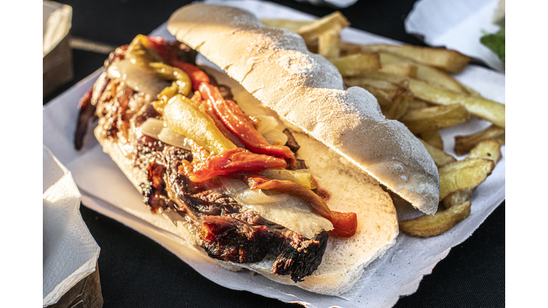 Meat sandwich with sauce, vegetables and French fries. Barbecue. Asado. Traditional Argentine food.
