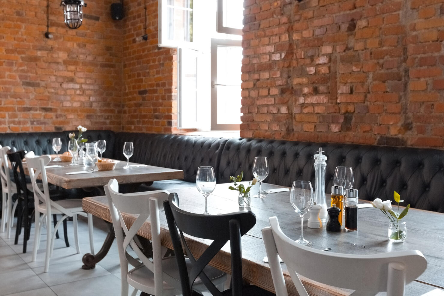 Empty chairs arranged by tables in brewery