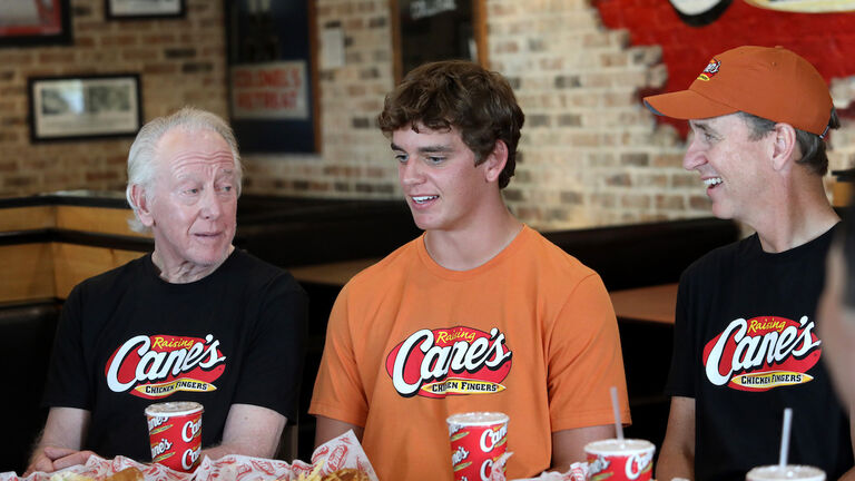 Arch, Cooper And Archie Manning Work A Pre-Manning Passing Academy "Shift" With LSU Quarterback Garrett Nussmeier At Raising Cane's Thibodeaux, Louisiana