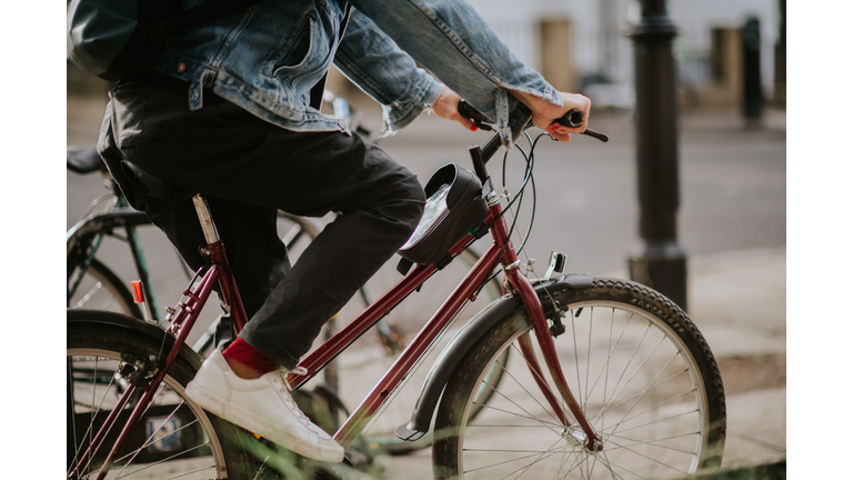 A man commutes to work in a UK city on a manual pedal bike