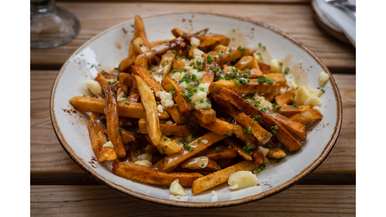 Plate with vegetarian food laying on wooden table