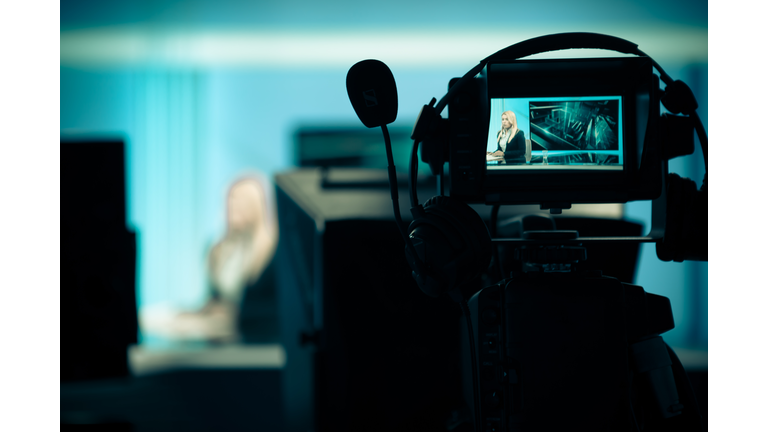 .Recording at TV studio with television anchorwoman