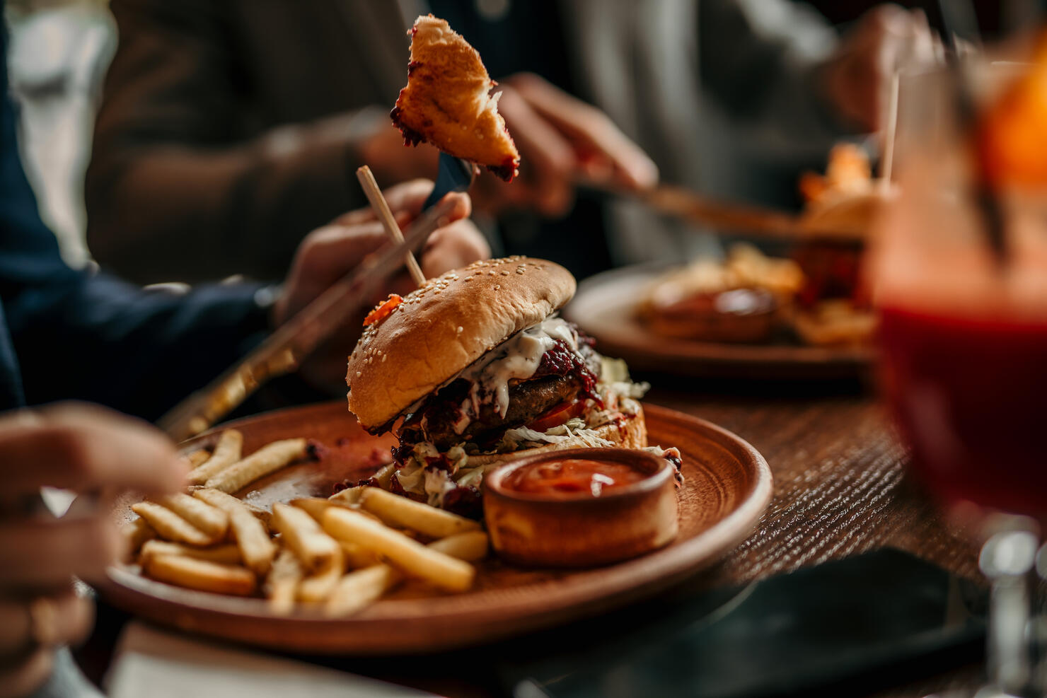 Burger and french fries served on a table in the restaurant