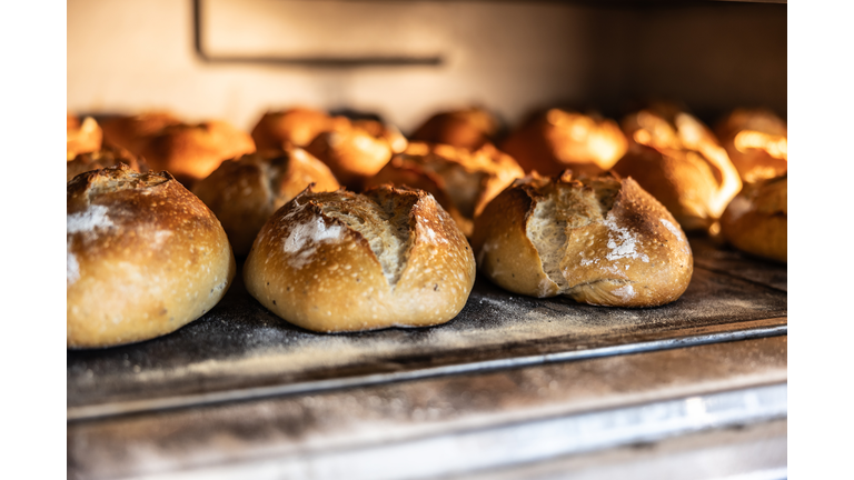 Freshly baked breads in the bakery oven - Close up.