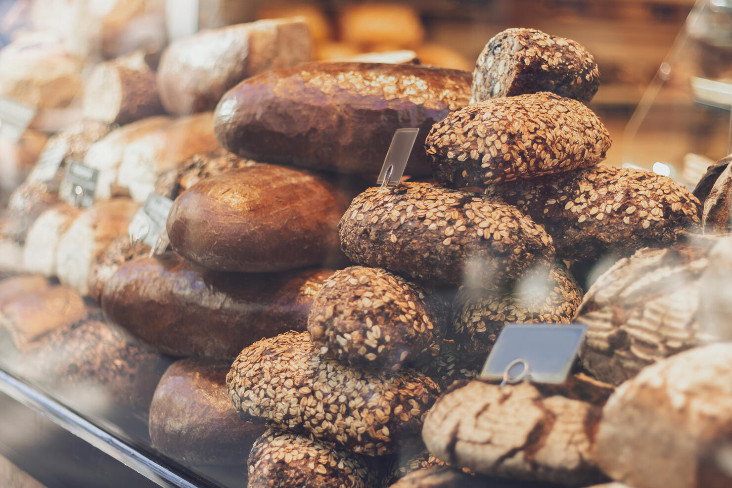 Loaves of bread displayed in the window of a bakery.