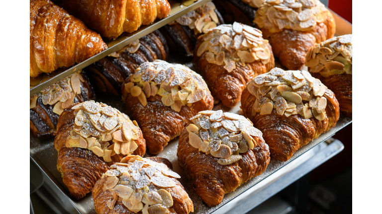 Freshly baked almond croissants display on tray