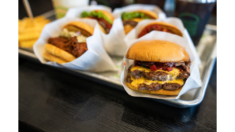 Street food. Meat cutlet burgers are in paper boxes. Food delivery