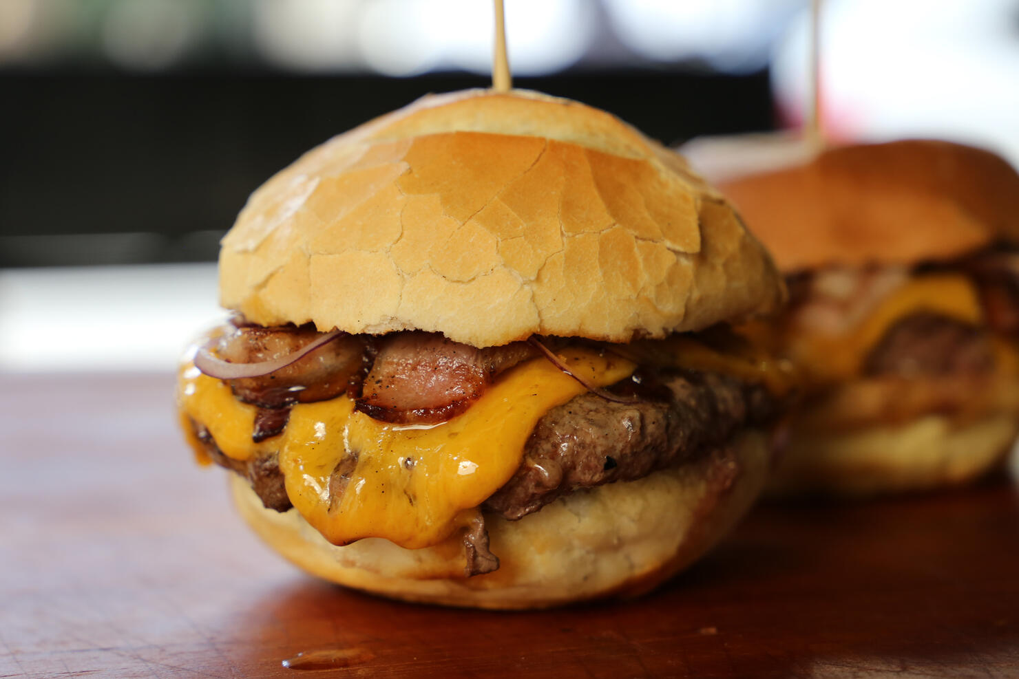 hamburger with cheese, tomato and bread made in barbecue grill. Side view. Close up