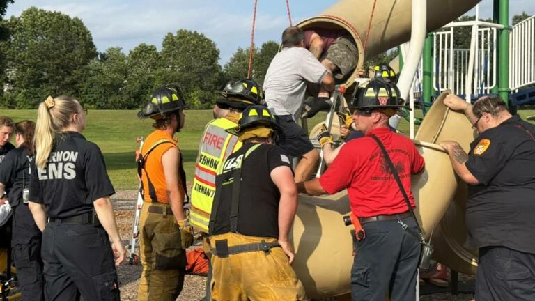 First responders rescue a man stuck in a playground slide
