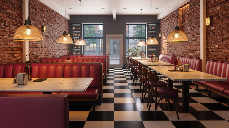 Cafe Interior With Red Seats, Marble Tables, Pendant Lights And Brick Walls