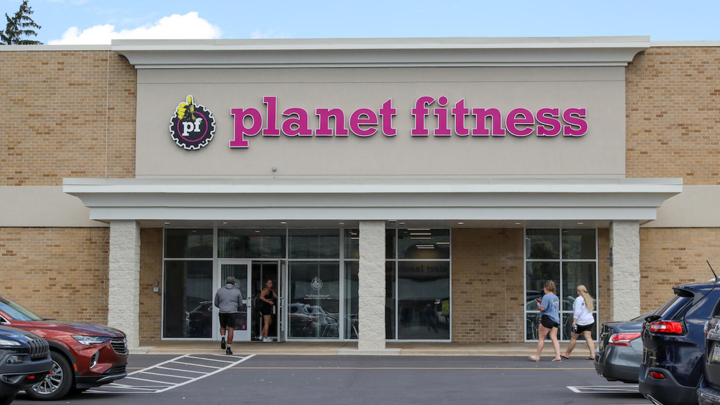 People are seen entering a Planet Fitness franchise. Planet