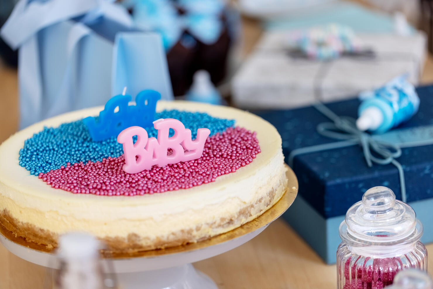 Pink and Blue cake on baby gender reveal party table