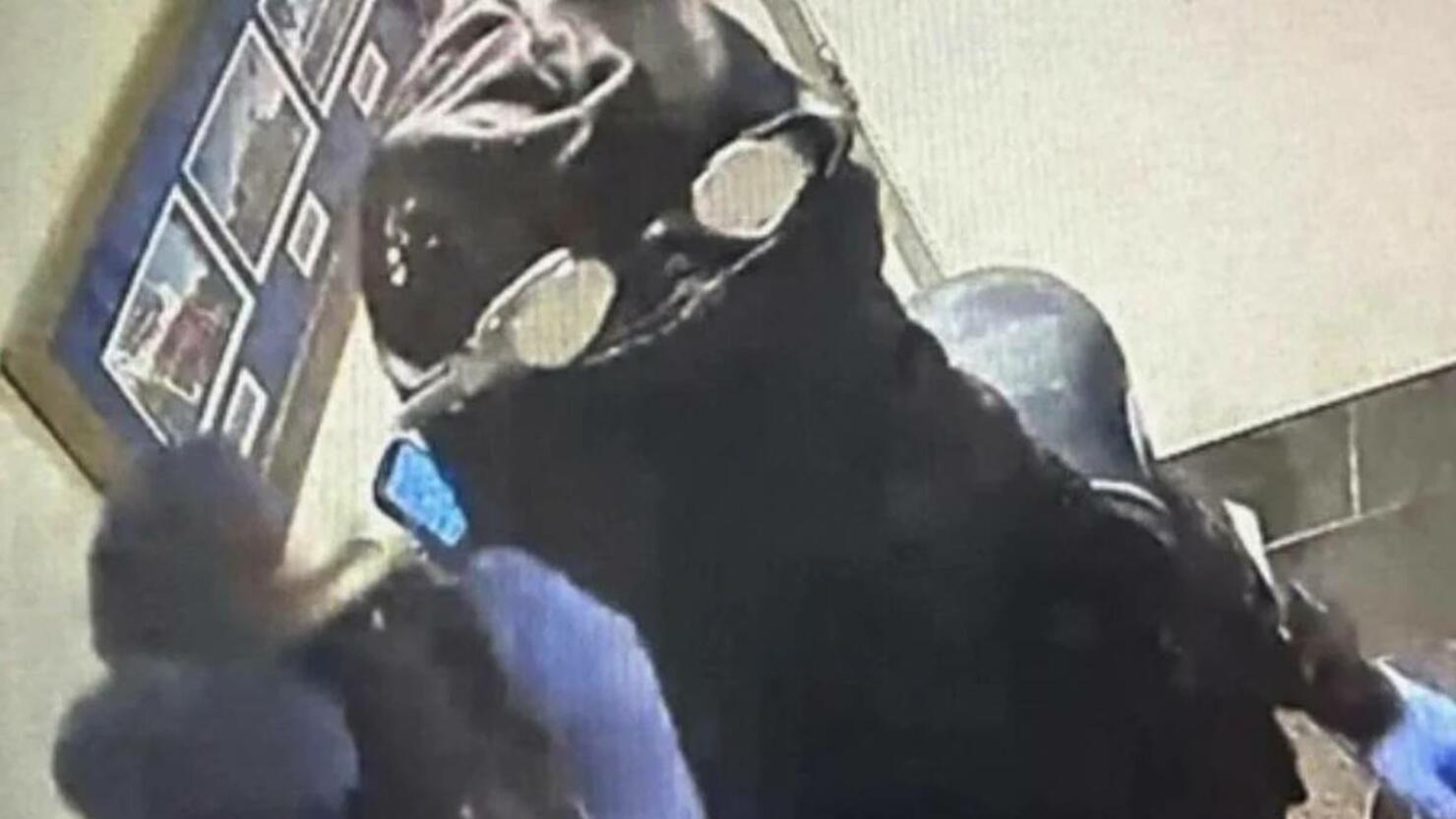 Surveillance footage of person in scuba gear robbing restaurant