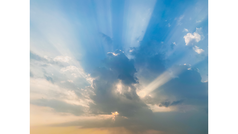 dramatic cloudy twilight sky with rays of light passing