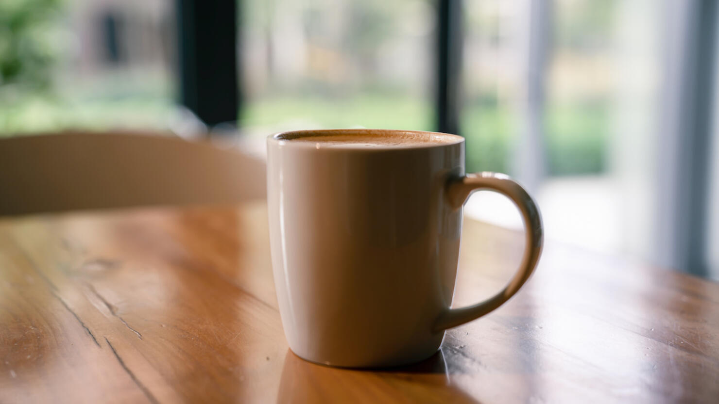 A cup of coffee on a wooden table