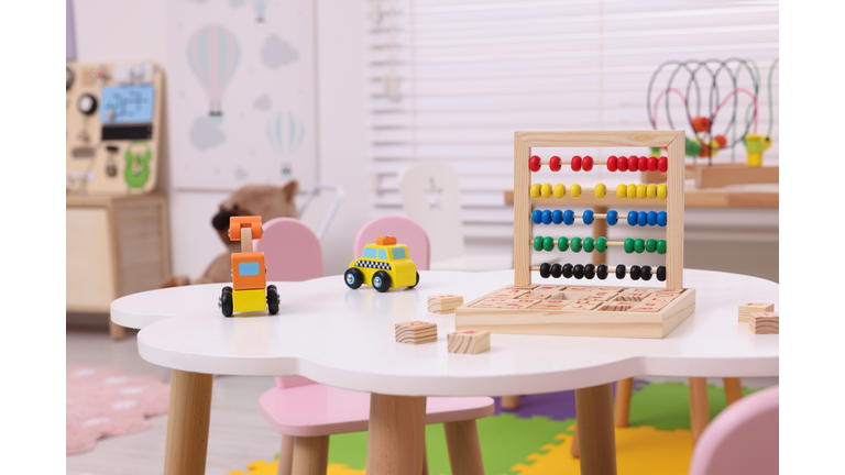 Different toys on table in playroom. Kindergarten interior