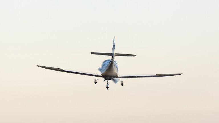small plane in the air. concept in articles and advertising materials related to aviation, air travel, private jets and flight school.