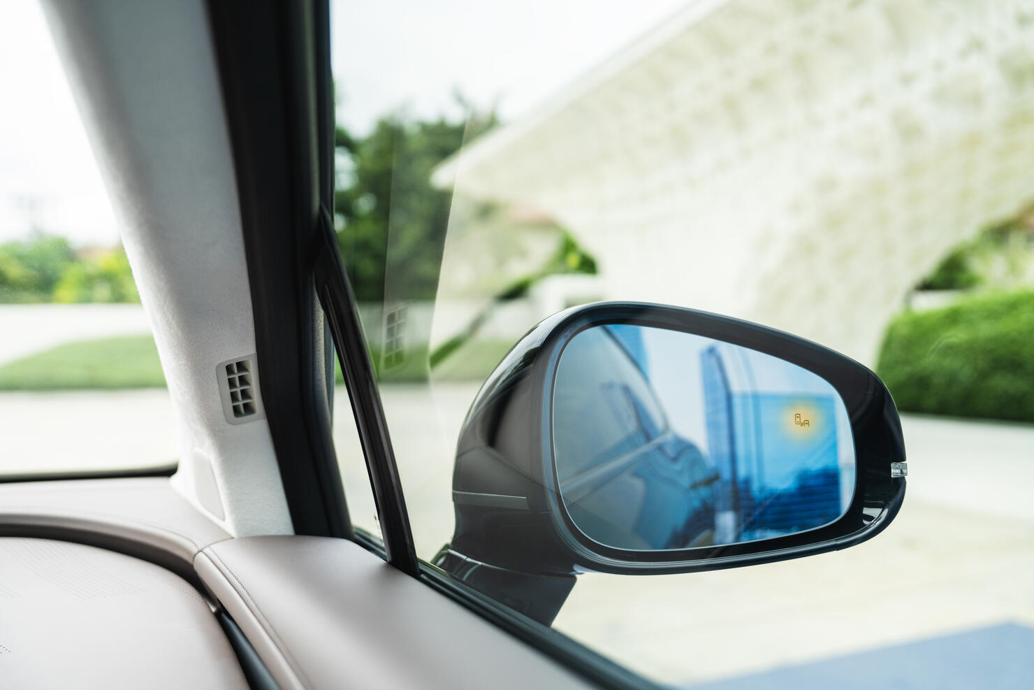 Car window side mirror on sunny day with truck traffic in reflection in Richmond
