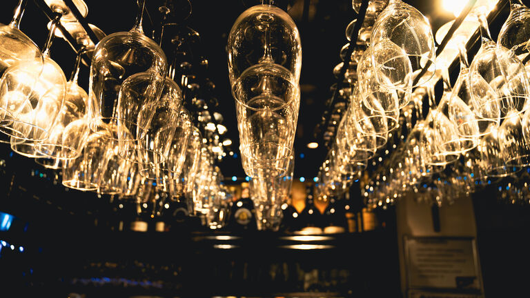 Inverted wine glasses in a bar