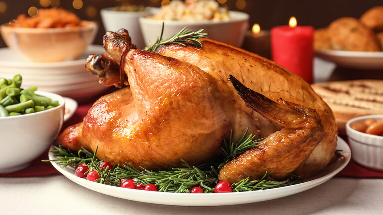 'Roasted Turkey with Festive Garnishes on White Plate'