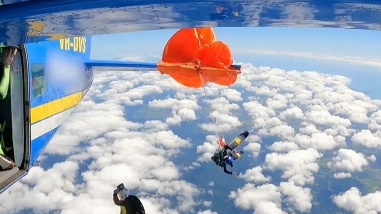 Skydiver hanging from plane after mishap