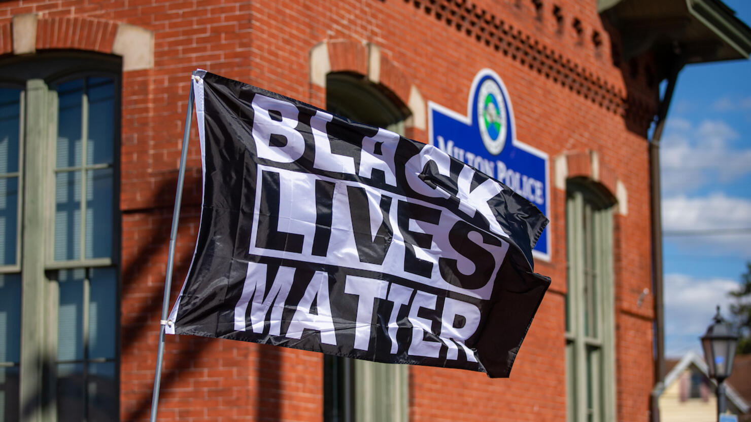 A Black Lives Matter flag flies outside the Milton Police