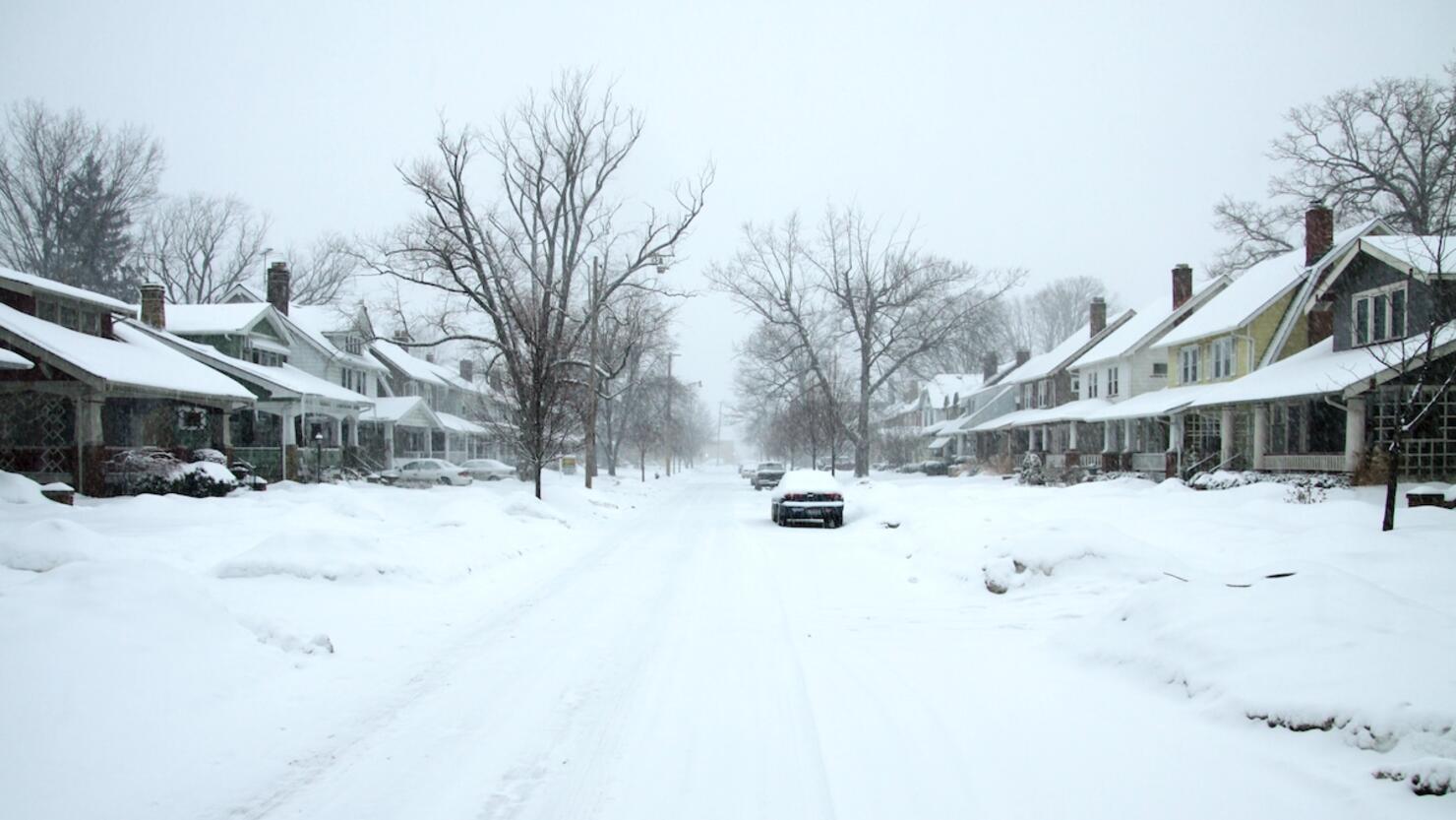 Residential street covered in a blanket of snow after the storm
