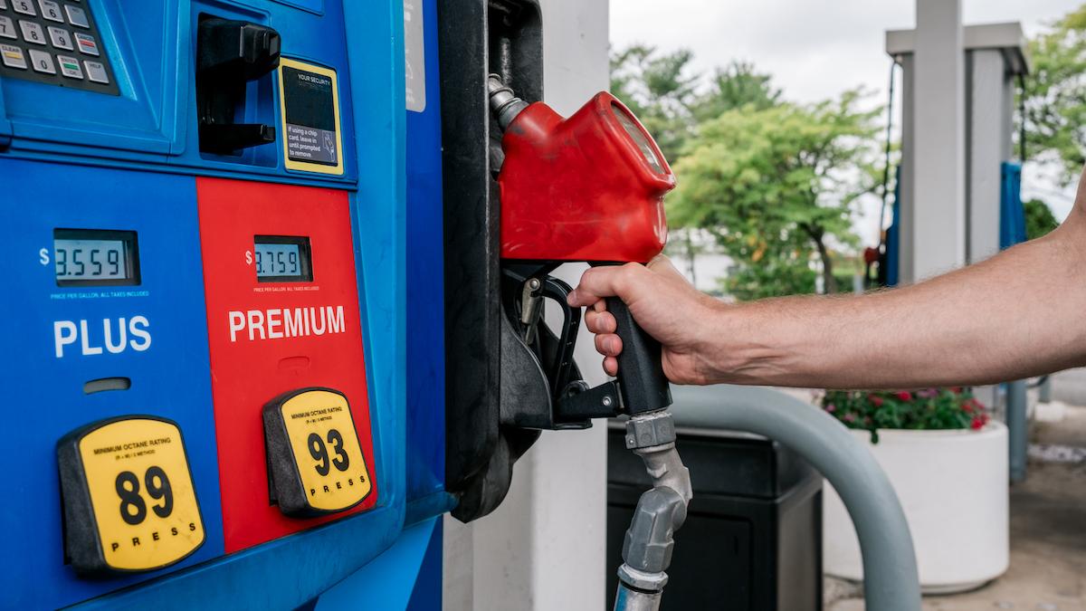 Man Refuels Car at Gas Station
