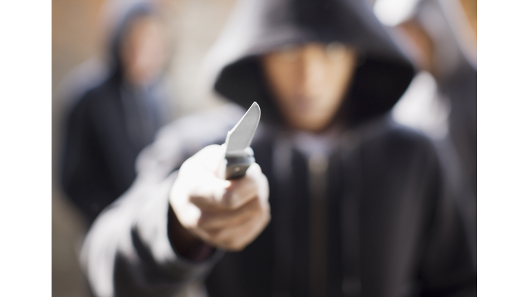 Man threatening with pocket knife (Credit: Paul Bradbury/Getty Images/Royalty Free)