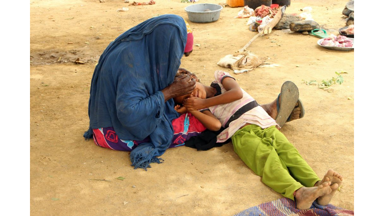 - A displaced Yemeni woman from Hodeida comforts a child in their shelter at a make-shift camp for displaced people in the northern district of Yemen's Hajjah province on June 19, 2018. - Fierce fighting in the Hodeida area has already driven 5,200 families from their homes as pro-government forces advanced up the Red Sea coast, according to the UN. (Credit: ESSA AHMED/AFP/Getty Images)